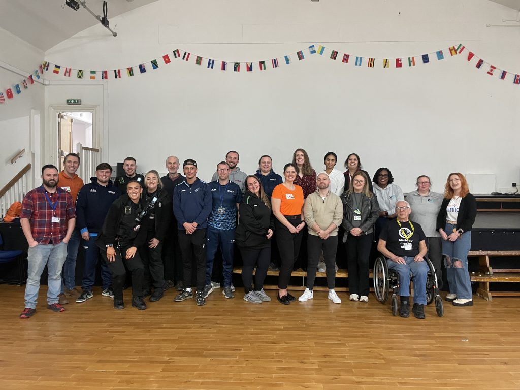Image of all the partners who took part in the Young Futures event smiling at the camera in a group